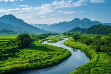 A lazy river winding through a lush green landscape, flanked by mountains in the distance under a wide sky