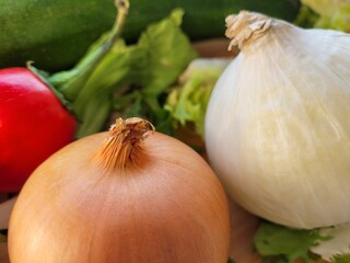 Raw onions and another vegetables in the kitchen.