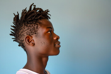 a young man with dreadlocks on his head