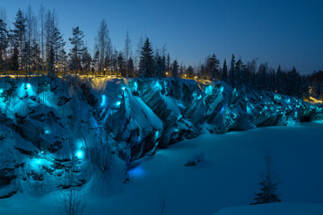 The shore of the Marble Canyon in aquamarine illumination on a January evening. Ruskeala Mountain...