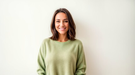 Happy woman wearing beige sweater smiling against white background 
