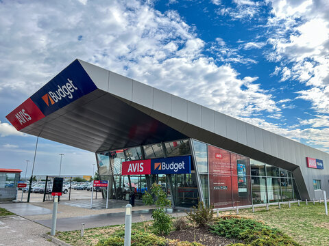 The office building of Avis and Budget car rental in airport of Lyon, France. Avis Budget Group is American car rental agency holding company.