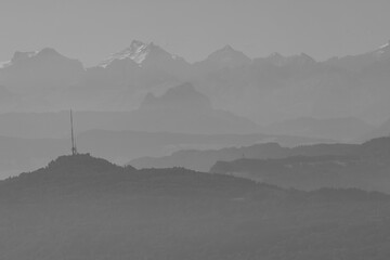 high angle view of the Uetliberg, lake of Zurich and the swiss alps in the background. Black and white picture. - obrazy, fototapety, plakaty