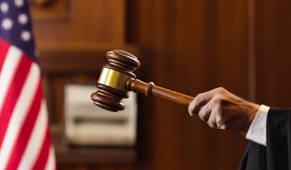 Judge holding of Judge hammer in courtroom. Justice in courthouse on law theme and human right. Punishment verdict of judges in court. Mallet of judge in USA courthouse during sentencing and trial.