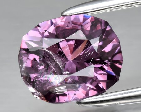natural purple spinel gem on the background