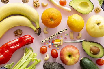 Supplements pills concept word with different fruits and vegetables on white background - 749903306