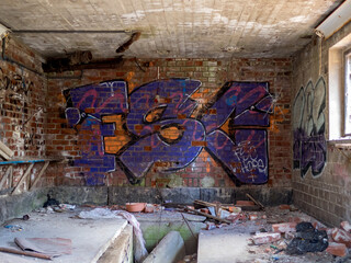 Wall covered in graffiti in an abandoned factory