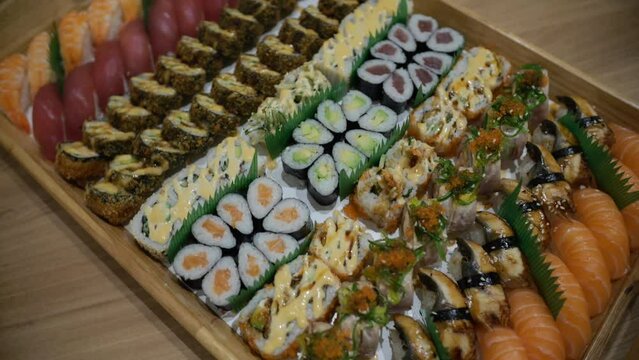 Assorted Sushi Platter with a Variety of Rolls and Nigiri on a Wooden Tray