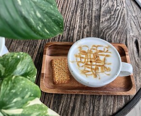 Cup of hot coffee on wooden table.