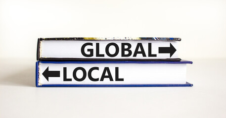 Global or local symbol. Concept word Global or Local on beautiful books. Beautiful white table white background. Business and global or local concept. Copy space.
