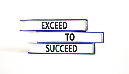 Exceed to succeed symbol. Concept words Exceed to succeed on beautiful books. Beautiful white table white background. Business and exceed to succeed concept. Copy space.