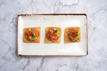 Tuna tartare or Salmon tartare with red caviar and avocado