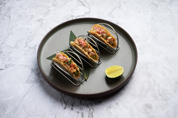Shrimps tacos with salsa, vegetables and avocado
