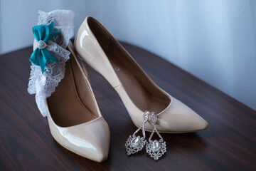 wedding photography of bridal accessories, white shoes, earrings, garter