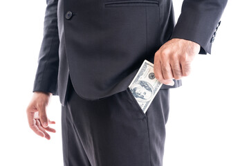 Close-up of a businessman in a suit discreetly holding cash, symbolizing bribery, corruption, or undercover payment.
