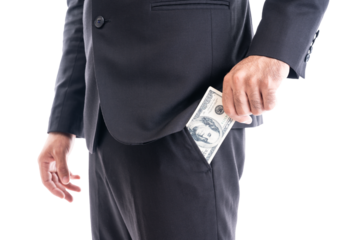 Close-up of a businessman in a suit discreetly holding cash, symbolizing bribery, corruption, or undercover payment.
