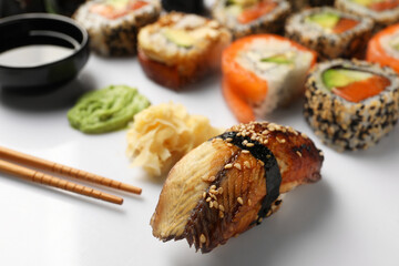 Set of delicious sushi rolls on white background, closeup