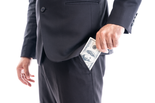 Close-up of a businessman in a suit discreetly holding cash, symbolizing bribery, corruption, or undercover payment.
