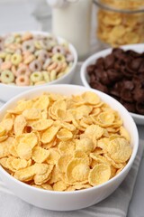 Different delicious breakfast cereals on table, closeup