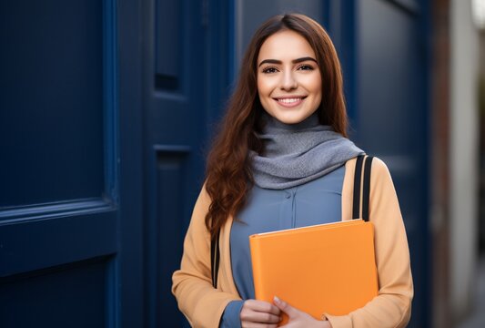 young irani woman student holding a folder and smiling