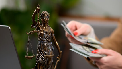 A young female lawyer at her workplace is counting money. The concept of corruption, bankruptcy...