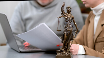 Obraz premium Business woman lawyer discussing agreement and legal contract with man, scales of justice on table in office. Law, legal services, consultation, justice and real estate concept.