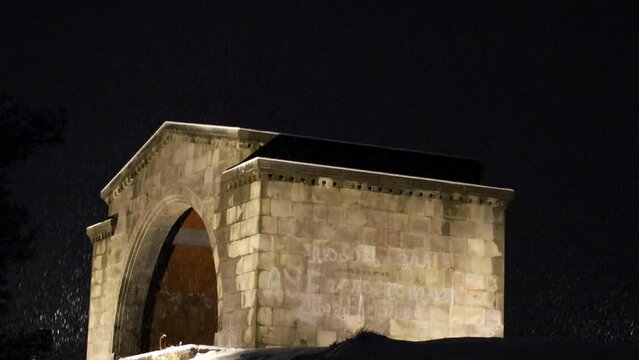 Charents arch in the serene snowy winter night, softly illuminated, against the tranquil night snow, captured from a low angle perspective, uhd, 4k, 3840, 2160
