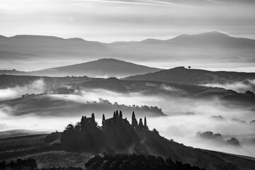 Cold morning fairy-tale black and white panorama, fog in mountains at sunrise, travel to magical...