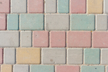 Close-up top view of multi colored tiled stine sidewalk on pedestrian city street. Copy space for...