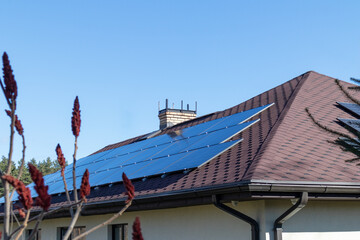 Fototapeta na wymiar Solar panels on the roof of the house