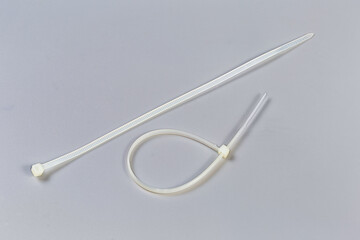One fastened and one unfastened nylon translucent cable ties