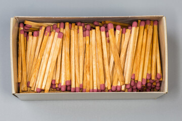 Large open matchbox with wooden safety matches, top view