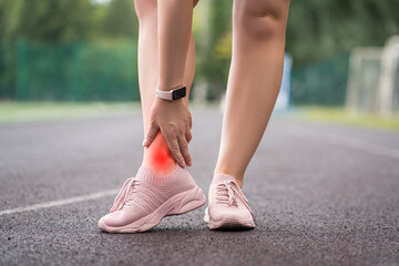 Achilles tendon injury, callus on the heel while running, foot pain, woman suffering from feet ache on a sports ground, podiatry concept - obrazy, fototapety, plakaty