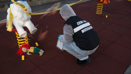 crime scene in a children's playground, where a child was kidnapped. the police present to catalog...