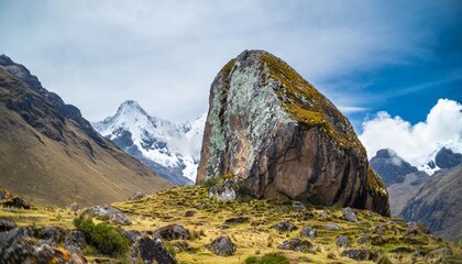 a large solitary rock covered in mold and lichen in a minimalist landscape of the peruvian mountains vertical - obrazy, fototapety, plakaty