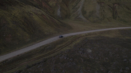 Car driving off-road terrain exploring the Fjallabak Natural Reserve. A 4x4 car driving dirt road traveling in Iceland sightseeing wilderness.