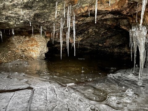 Icicles and a frozen pond in a cave