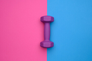 Layout of one dumbbell 2 kg purple on a blue-pink background, top view. Concept of healthy...