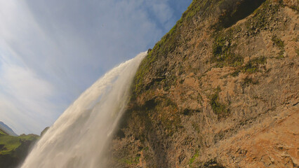 The Seljalandsfoss waterfall on the south coast of Iceland bathed in the otherworldly light of the...
