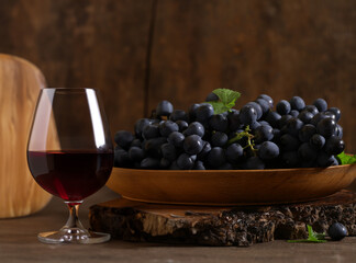 fresh grapes and red wine in a glass