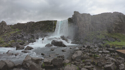 Oxararfoss is a waterfall situated within Þingvellir National Park in Southwest Iceland. The waterfall flows out the river Oxará, cascading in two drops over the cliffs of Almannagjá gorge.