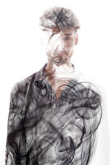 A full-front portrait of a man combined with swirling smoke in double exposure