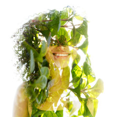 A double exposure portrait of a young woman combined with green foliage