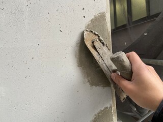 worker painting a wall with a brush