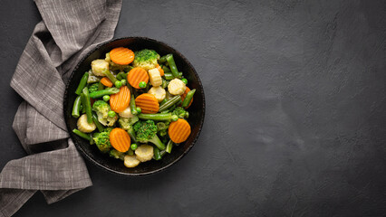 Healthy organic steamed vegetables with carrots, broccoli and spinach. View from above.
