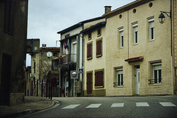 City street with old houses and a narrow road in France