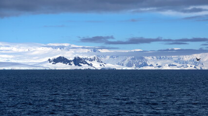 Fototapeta na wymiar Snow covered mountains around a bay at Portal Point, Antarctica