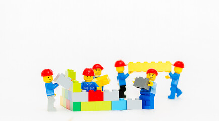 Naklejka premium Orvieto, Italy - January 16th 2015: team of workman Lego mini figure build a wall. Lego is a popular line of construction toys manufactured by the Lego Group