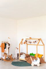 Kids room interior in contemporary, Scandinavian style. Wooden bed, sofa and toys. Cozy room for child. - 749984335