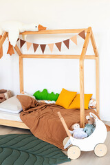 Kids room interior in contemporary, Scandinavian style. Wooden bed, sofa and toys. Cozy room for child. - 749984386